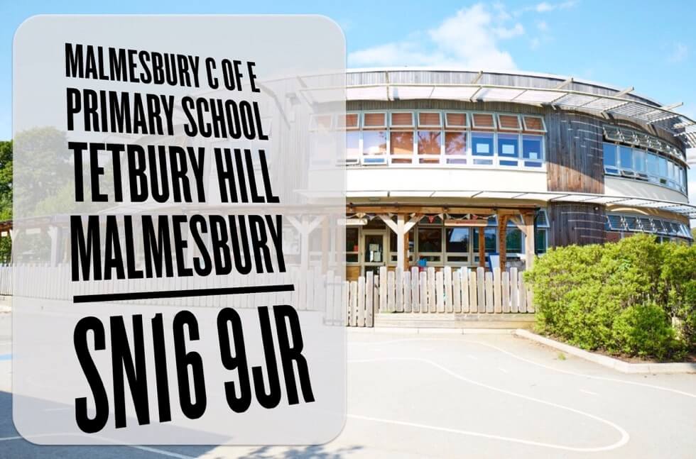 Malmesbury C of E Primary School building, with a sign giving the school address