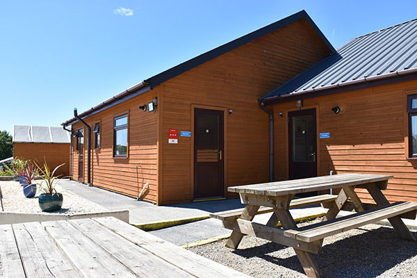 Exterior photo of the Morfa Bay residential accommodation buildings and picnic area