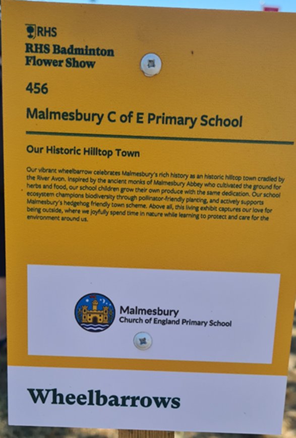 RHS Badminton Flower Show sign for Malmesbury C of E Primary School's wheelbarrow, Our Historic Hilltop Town